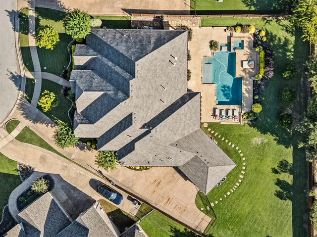 an aerial view of a house with a yard