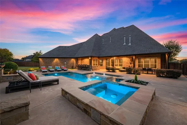 a view of a house with pool and chairs