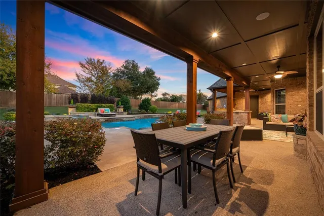 a view of a porch with dining table and chairs with a swing