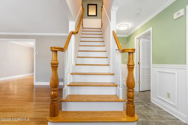 a view of entryway and hall with wooden floor