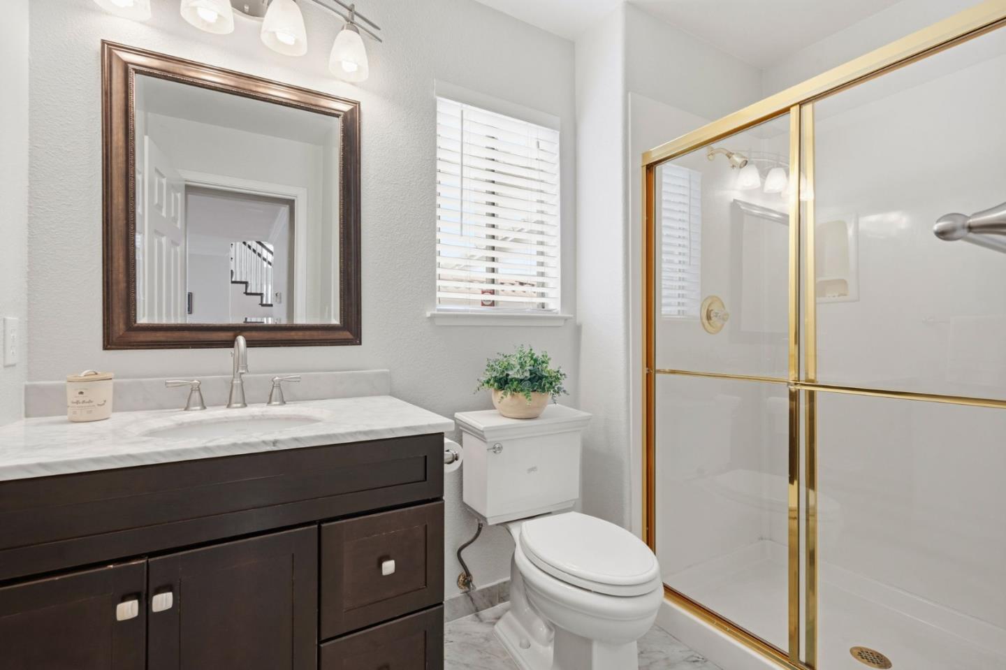 35 Sierra Ridge Court Danville, CA 94506 - Photo 15 of 37 a bathroom with a toilet a sink and a mirror