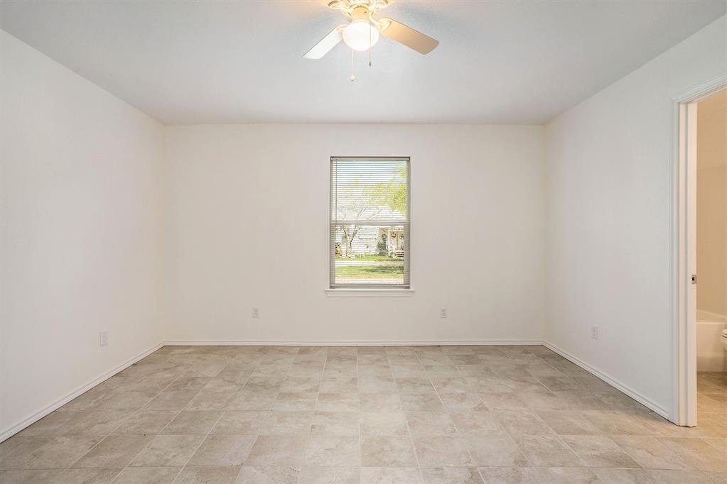 405 North Cleburne Whitney Road Rio Vista, TX 76093 - Photo 17 of 23 Recessed window with white trim, ceiling fan with integrated lighting, and tile flooring