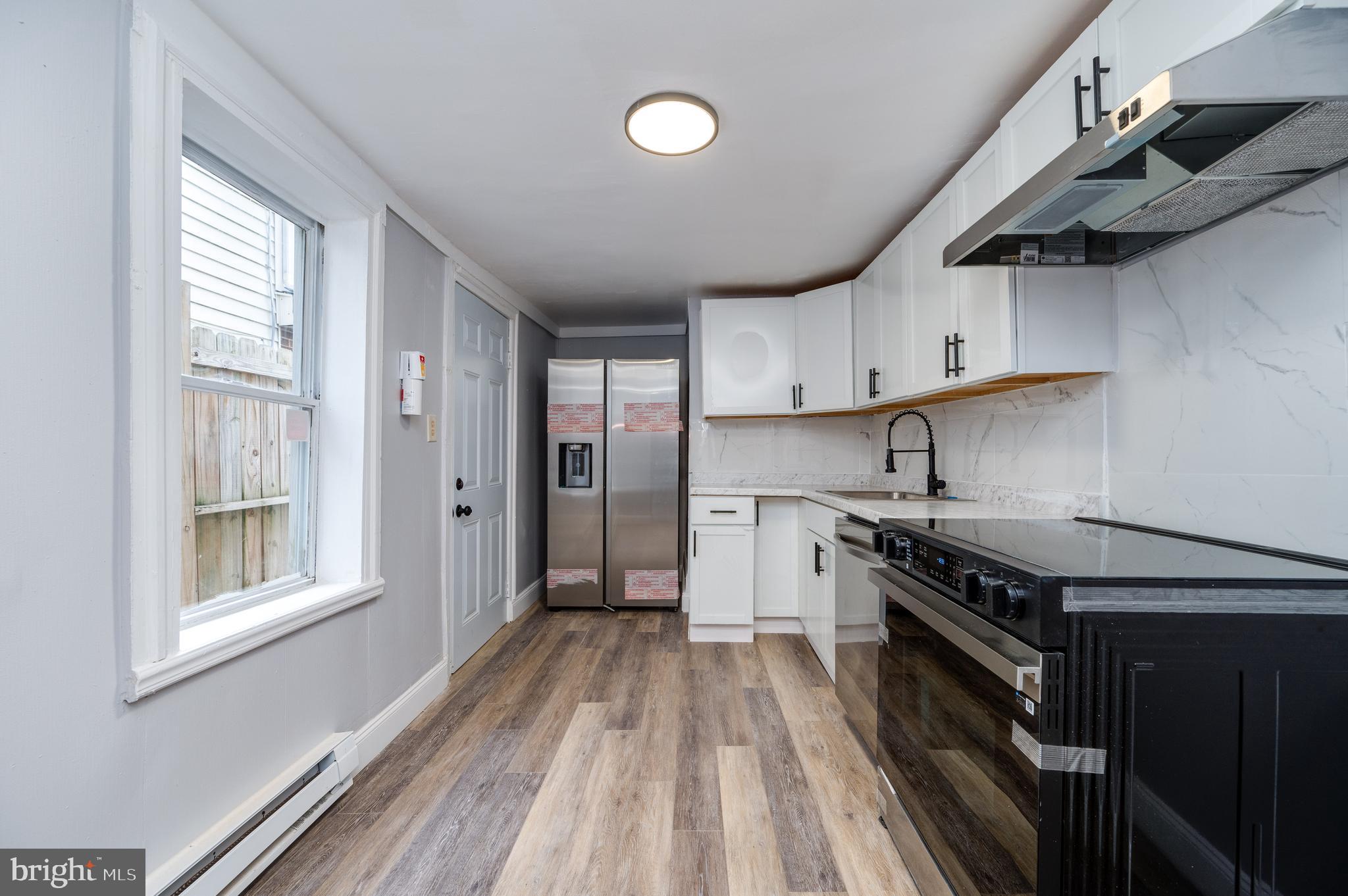 1724 Cotton Street Reading, PA 19606 - Photo 7 of 29 a kitchen with stainless steel appliances granite countertop a stove and a refrigerator