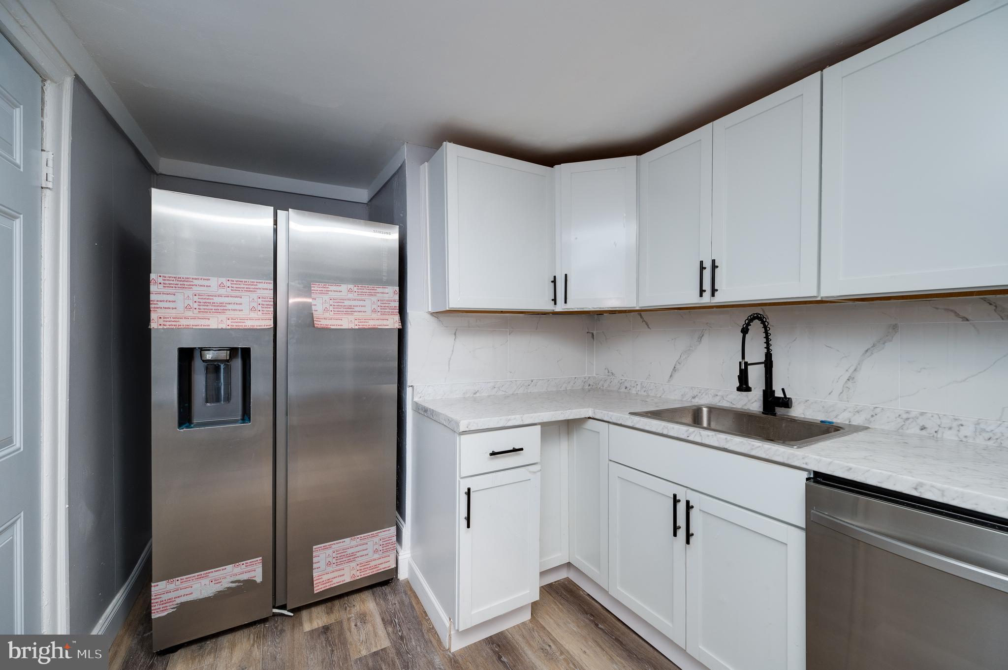 1724 Cotton Street Reading, PA 19606 - Photo 9 of 29 a kitchen with stainless steel appliances granite countertop a refrigerator sink and cabinets