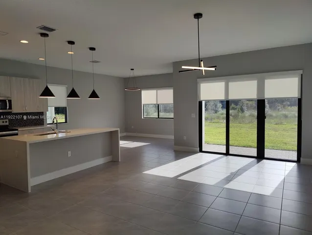 a view of a field with an trees in the background