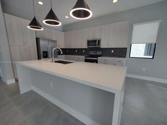 a view of an empty room with a floor to ceiling window and a ceiling fan