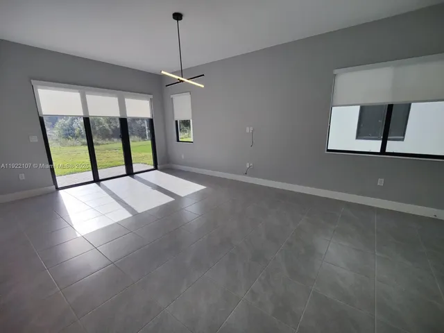 an empty room with a empty space and a window