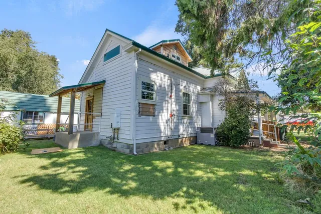 a kitchen with a white cabinets a sink a window and stainless steel appliances