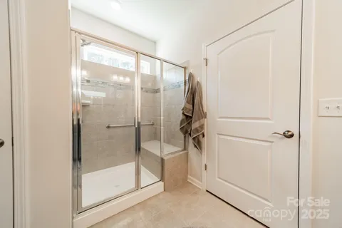a bathroom with a glass shower door