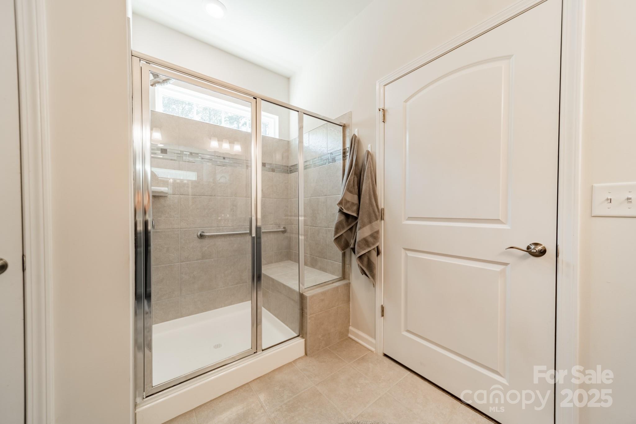 508 Vermeer Court Mount Holly, NC 28120 - Photo 12 of 24 a bathroom with a glass shower door