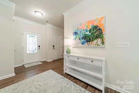 wooden floor with white walls and window