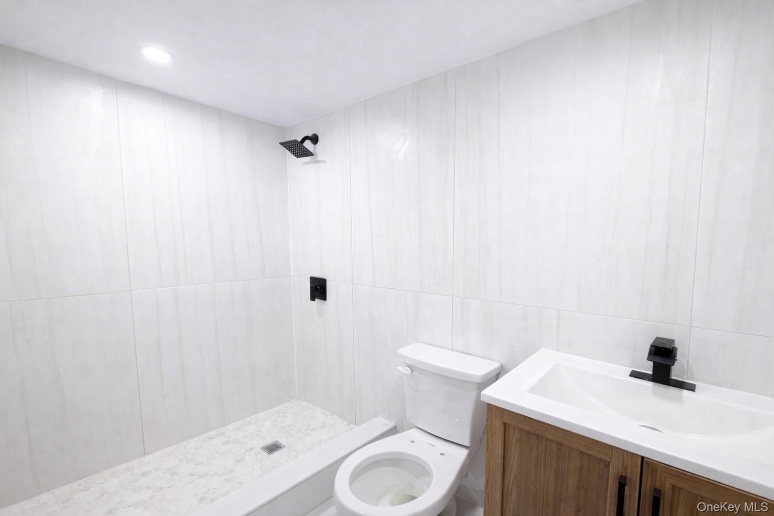 108-39 Union Turnpike Queens, NY 11375 - Photo 8 of 13 a bathroom with a sink a toilet and a mirror