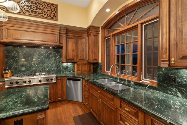 5615 East Eight Mile Gap Road Kanab, UT 84741 - Photo 14 of 81 Kitchen with decorative backsplash, wood finish cabinetry, dark stone counters, and stainless steel appliances