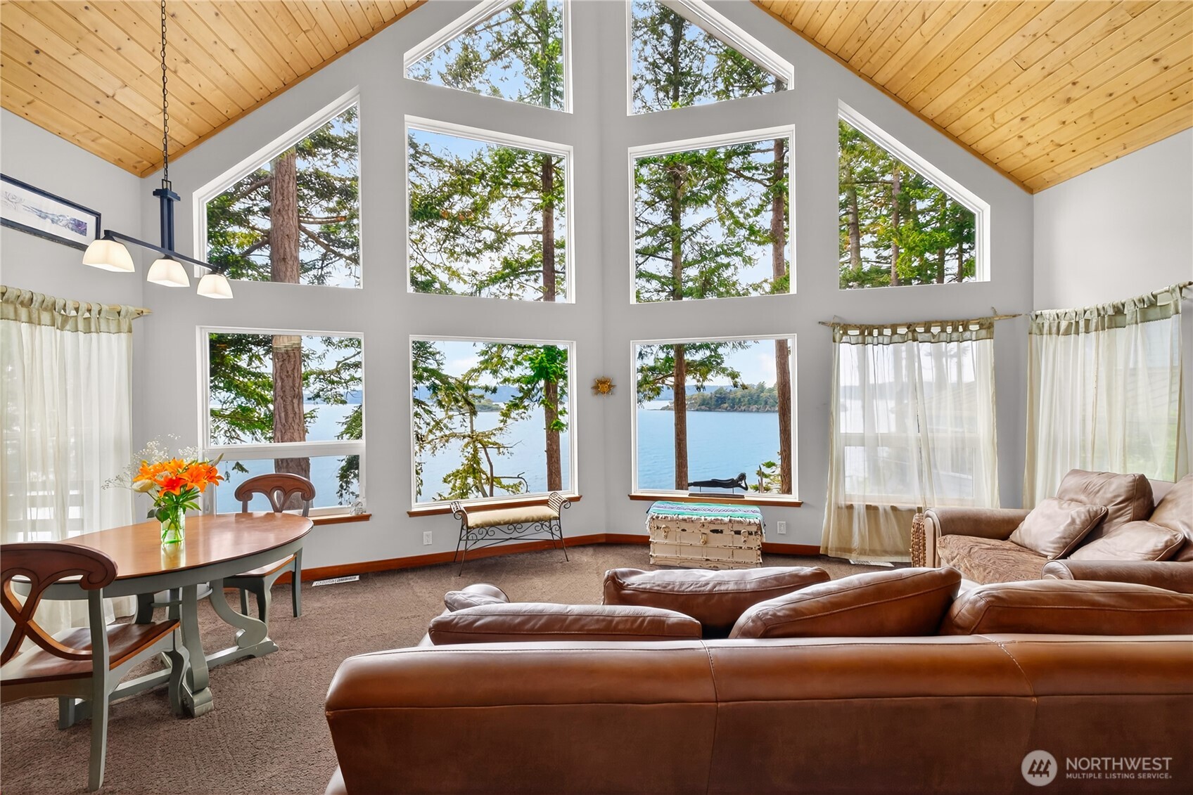 17946 Cobahud Road La Conner, WA 98257 - Photo 20 of 40 a living room with furniture and floor to ceiling windows