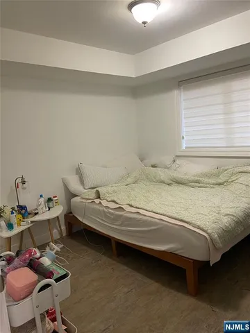 a bedroom with a bed a table and chair