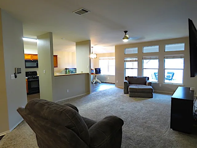 a living room with furniture and a large window