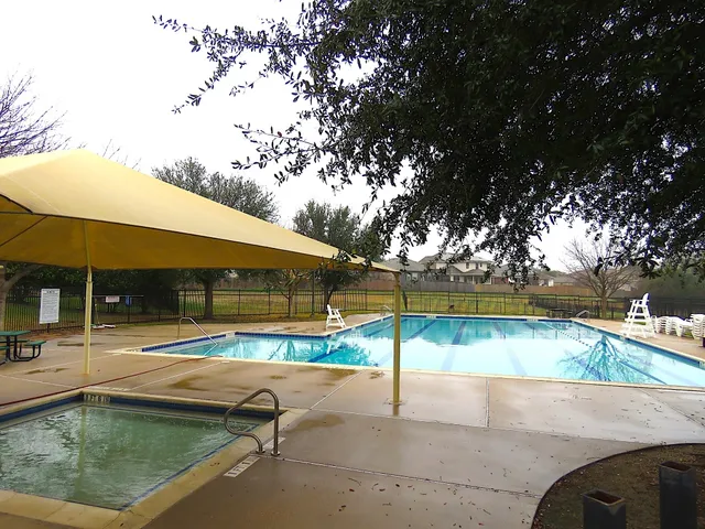 a view of a swimming pool with a yard