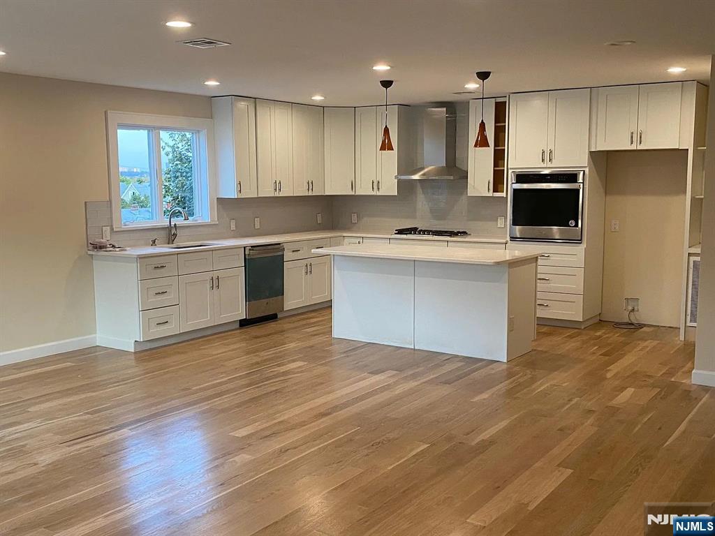a kitchen with a refrigerator sink and stove