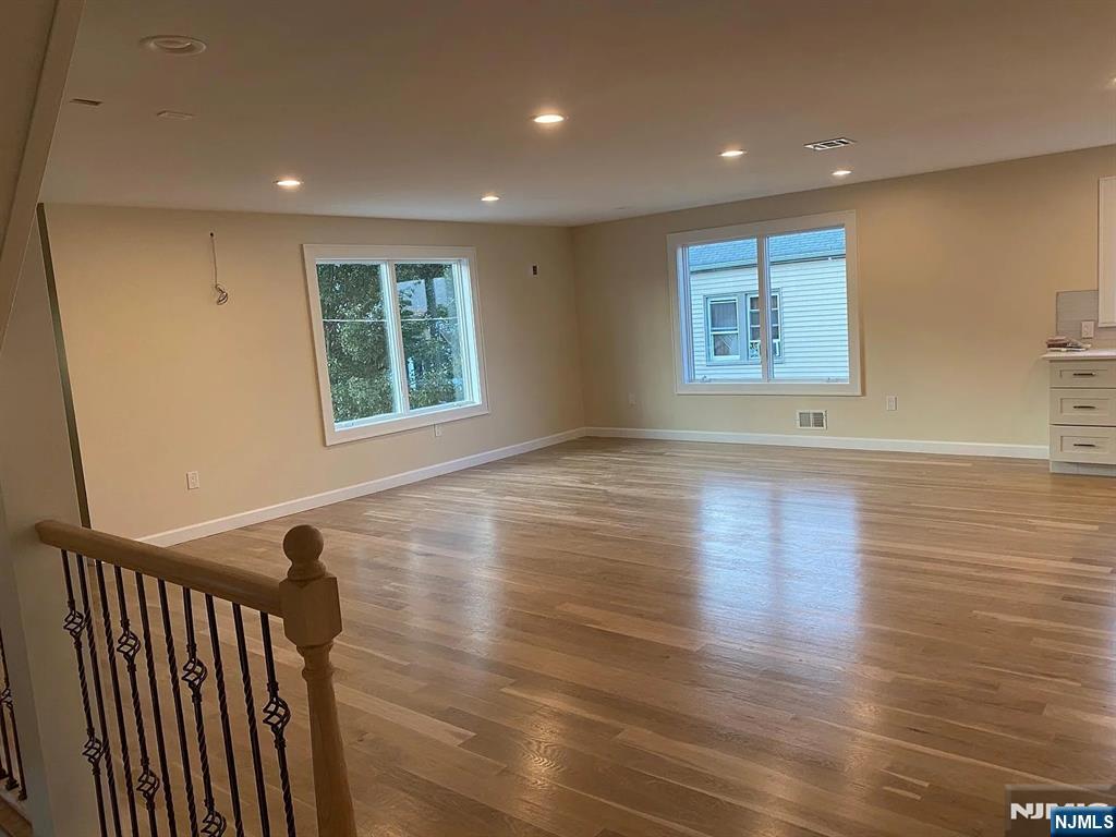 353 Hoboken Road Carlstadt, NJ 07072 - Photo 2 of 12 an empty room with wooden floor and windows