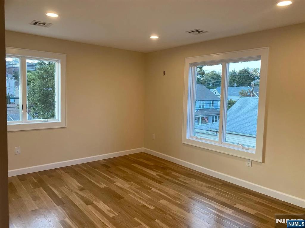 353 Hoboken Road Carlstadt, NJ 07072 - Photo 4 of 12 a view of a room with wooden floor and windows