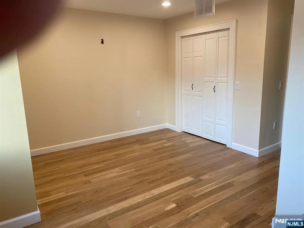 353 Hoboken Road Carlstadt, NJ 07072 - Photo 5 of 12 a view of empty room with wooden floor