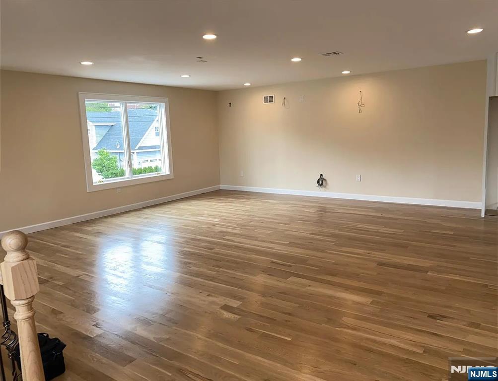 353 Hoboken Road Carlstadt, NJ 07072 - Photo 6 of 12 an empty room with wooden floor and windows