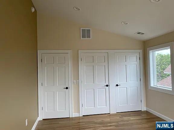 353 Hoboken Road Carlstadt, NJ 07072 - Photo 10 of 12 a view of an empty room with window and wooden floor