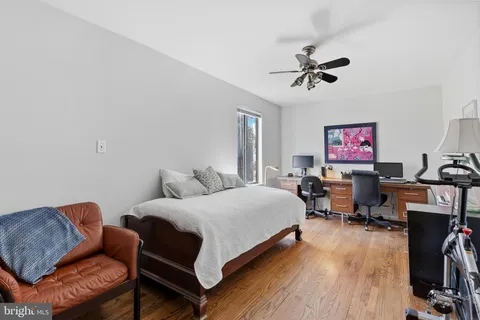 a living room with furniture a couch and wooden floor