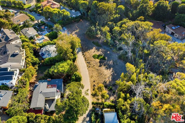 a view of a road with a house in the background