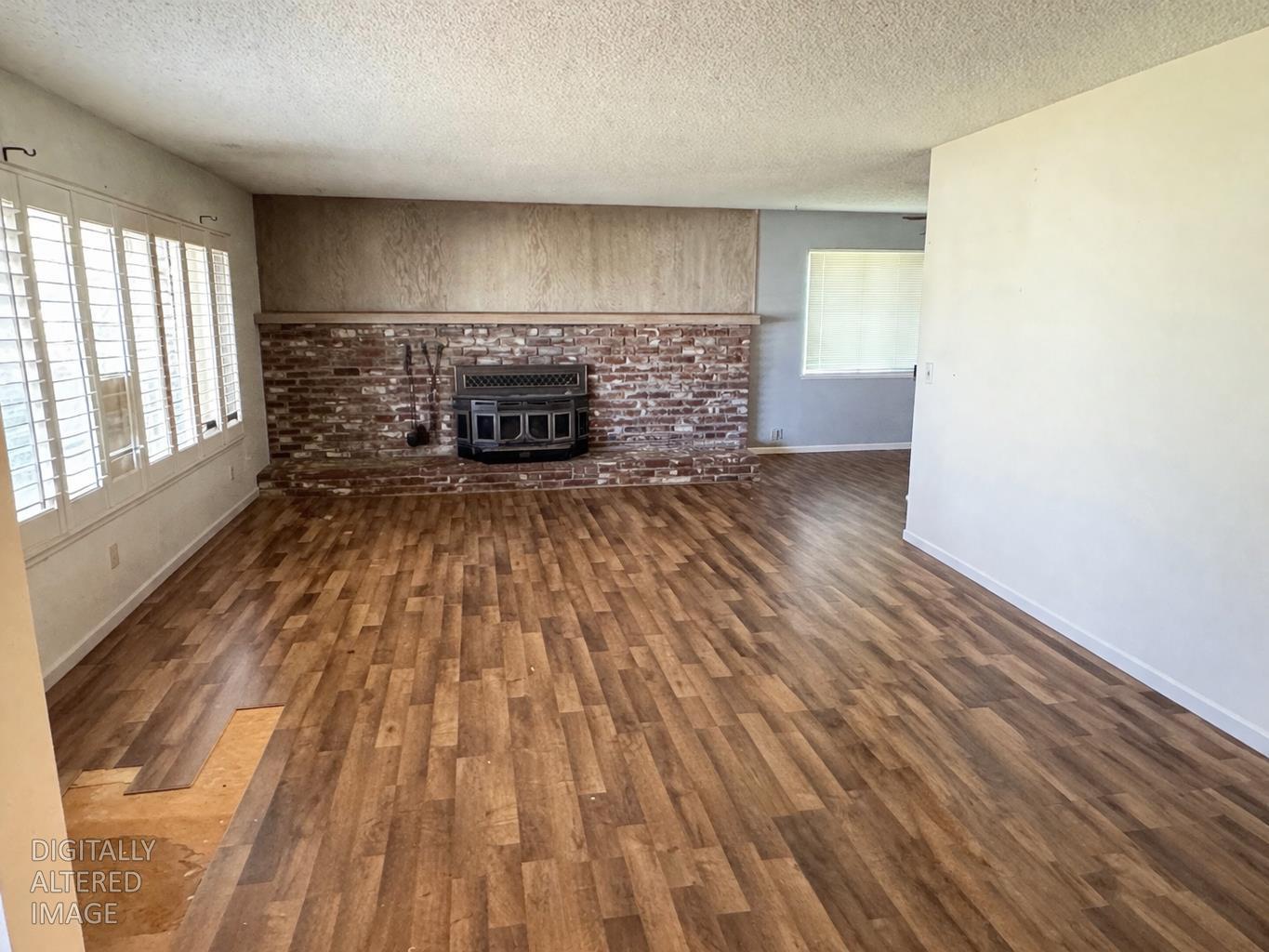 13080 Lone Star Road Auburn, CA 95602 - Photo 5 of 14 a view of empty room with wooden floor and fireplace