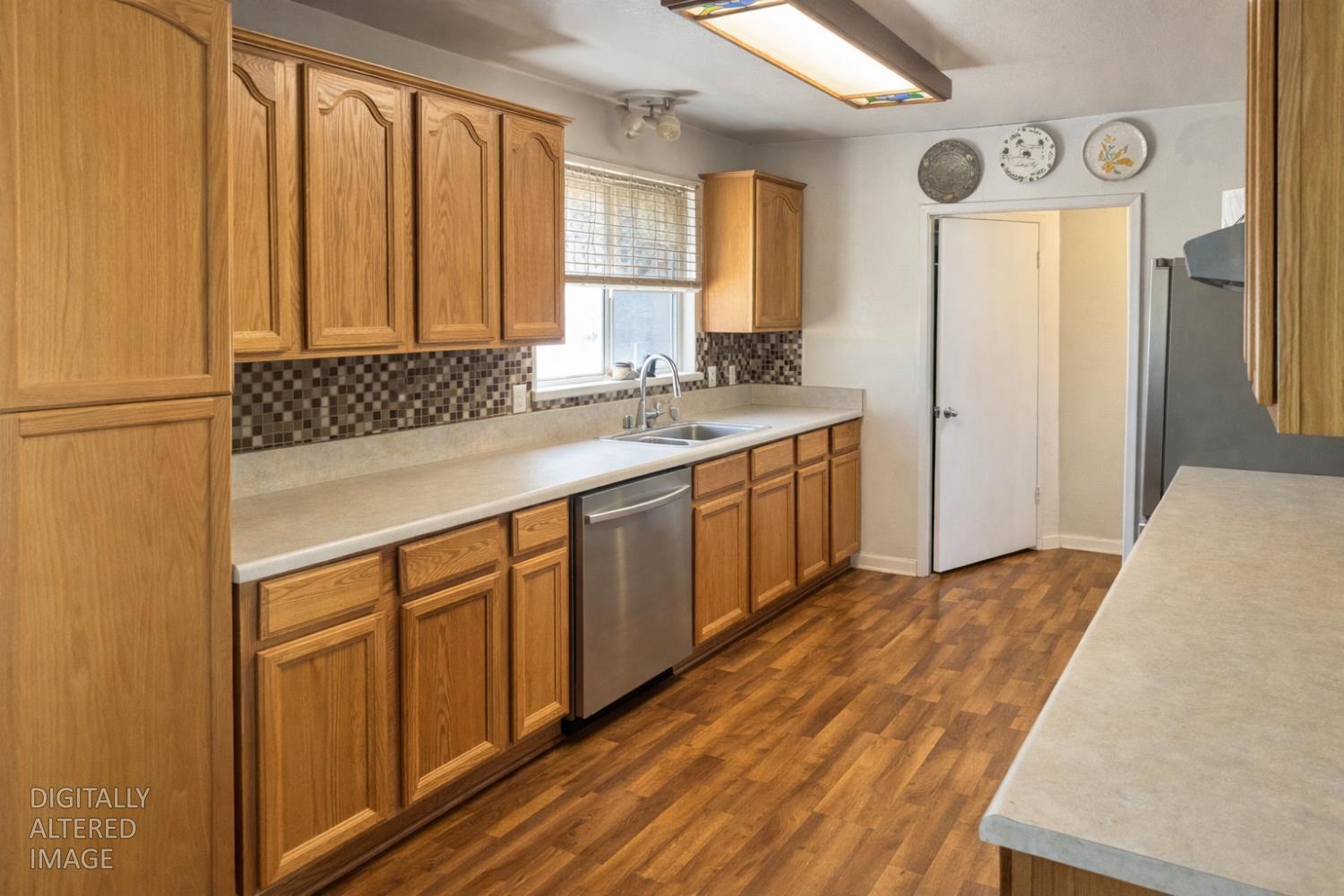 13080 Lone Star Road Auburn, CA 95602 - Photo 6 of 14 a kitchen with stainless steel appliances granite countertop a sink a stove cabinets and wooden floor