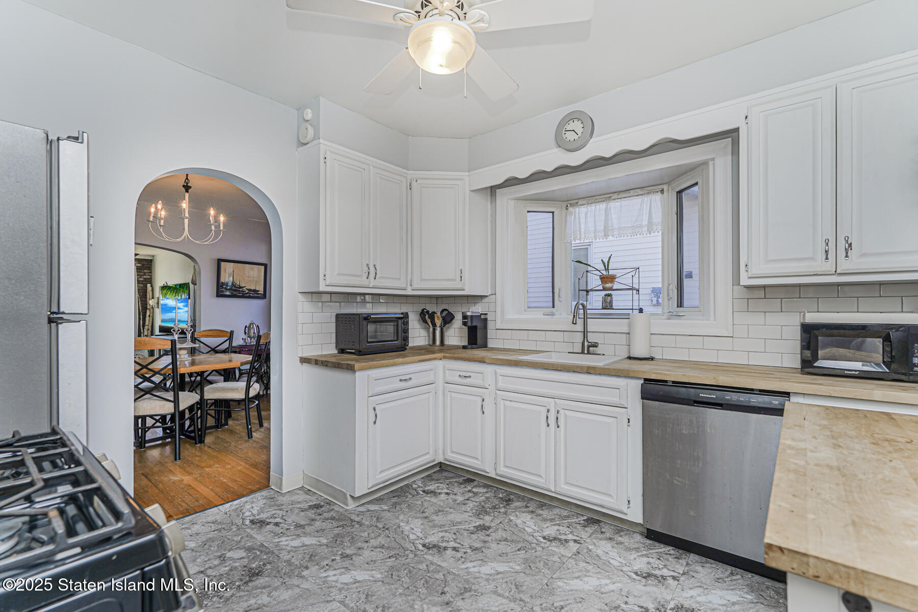 334 Neal Dow Avenue Staten Island, NY 10314 - Photo 11 of 37 a kitchen with a sink stove and cabinets