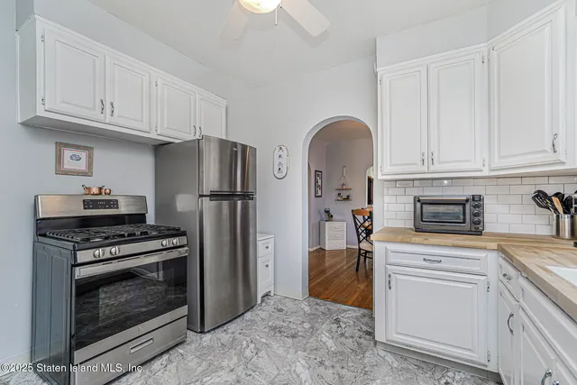 a kitchen with granite countertop a stainless steel appliances and cabinets