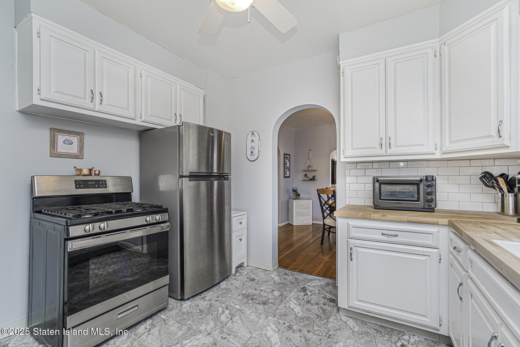 334 Neal Dow Avenue Staten Island, NY 10314 - Photo 12 of 37 a kitchen with granite countertop a stainless steel appliances and cabinets