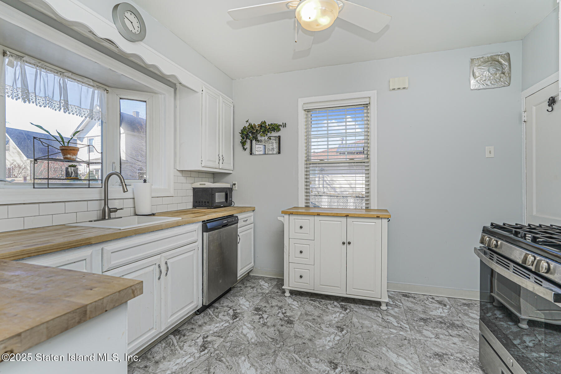 334 Neal Dow Avenue Staten Island, NY 10314 - Photo 13 of 37 a kitchen with cabinets appliances and a window