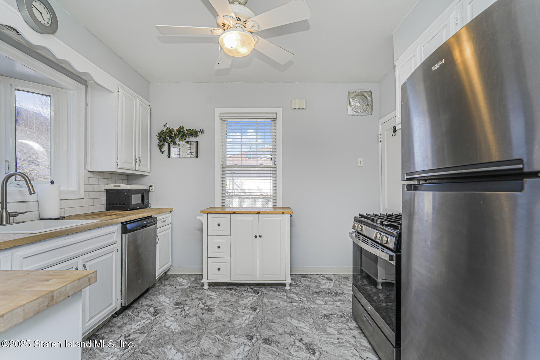 334 Neal Dow Avenue Staten Island, NY 10314 - Photo 14 of 37 a kitchen with a refrigerator and a sink