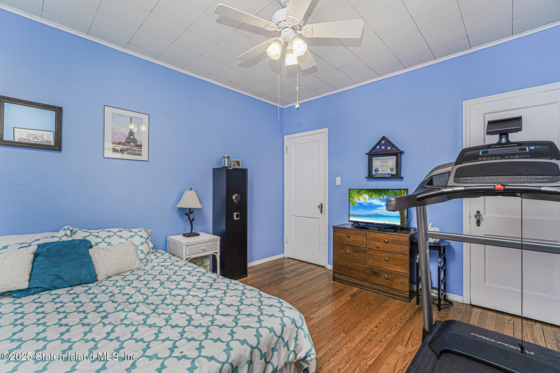 334 Neal Dow Avenue Staten Island, NY 10314 - Photo 17 of 37 a bedroom with a bed and a chandelier