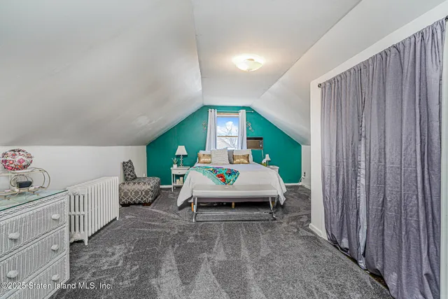 a bedroom with furniture and a large window