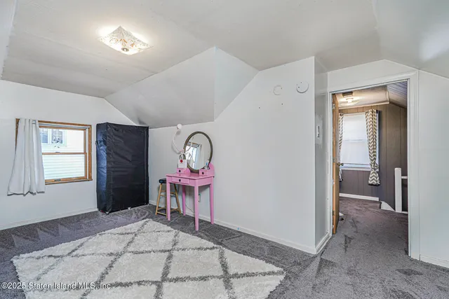 a view of a livingroom with furniture and a window