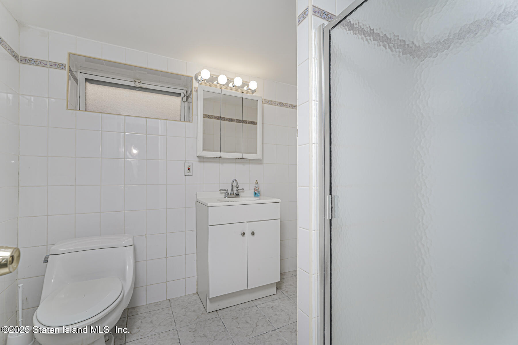 334 Neal Dow Avenue Staten Island, NY 10314 - Photo 33 of 37 a bathroom with a toilet a sink and mirror