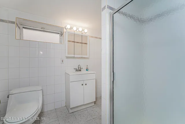 a bathroom with a toilet a sink and shower