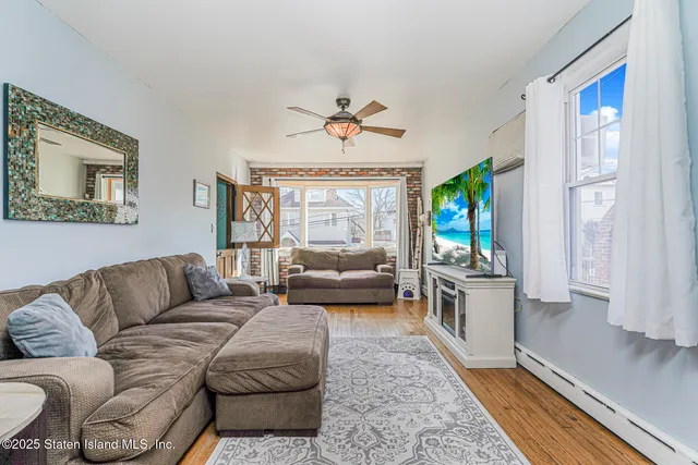 a living room with furniture or couch and a chandelier