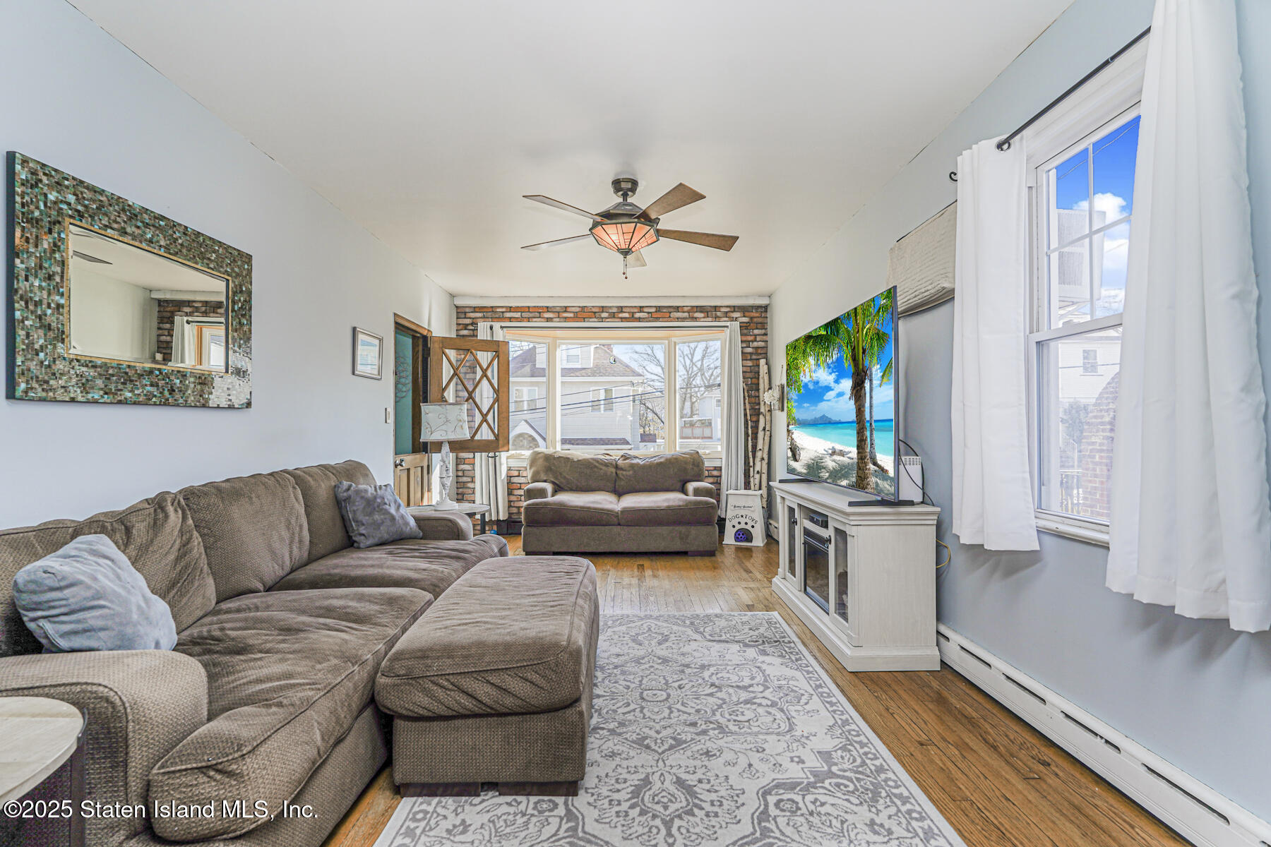 334 Neal Dow Avenue Staten Island, NY 10314 - Photo 5 of 37 a living room with furniture or couch and a chandelier