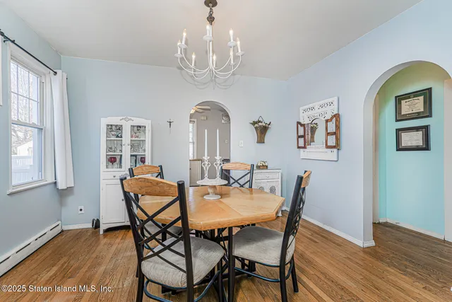 a view of a dining room with furniture and wooden floor