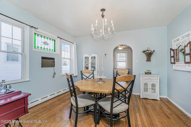 a view of a dining room with furniture wooden floor and chandelier