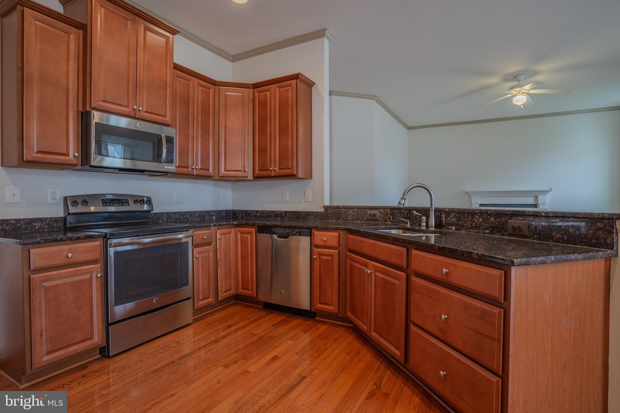 127 Glenbrook Road Ranson, WV 25438 - Photo 8 of 50 a kitchen with stainless steel appliances granite countertop a sink stove and microwave