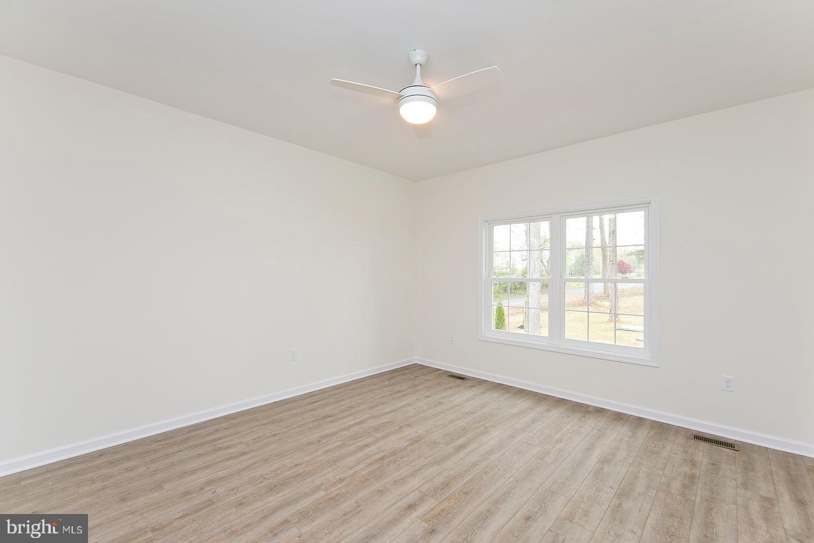 320 Pine Grove Road Bluemont, VA 20135 - Photo 2 of 28 an empty room with wooden floor and windows