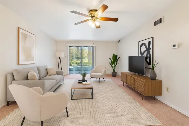 a living room with furniture and a large window
