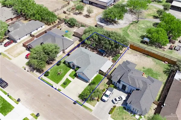 an aerial view of a house with a yard