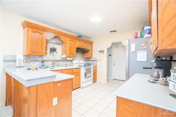 a bathroom with a toilet sink vanity and mirror